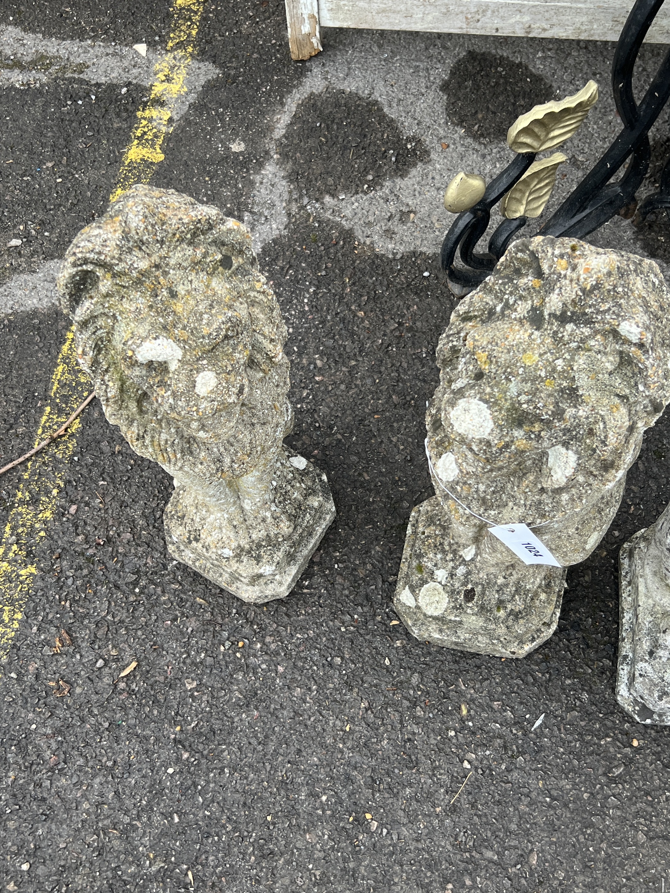 A pair of reconstituted stone seated lion garden ornaments, height 55cm